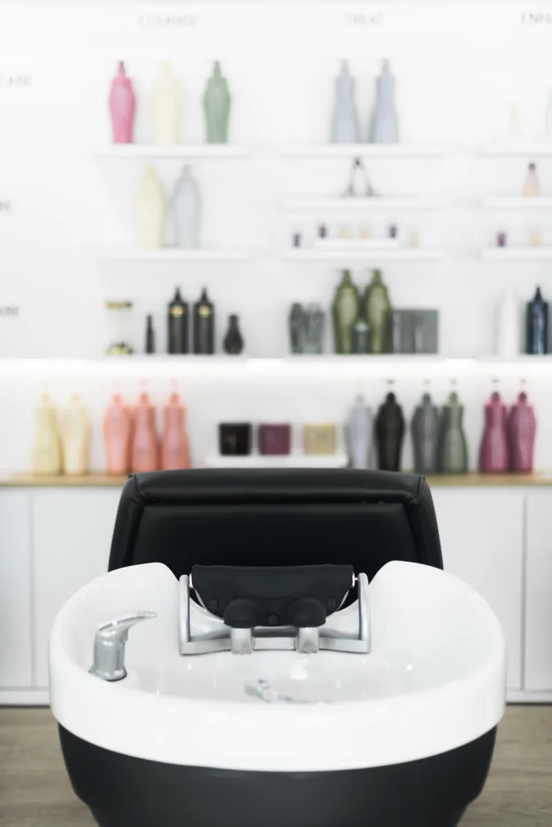 Hair wash station in front of the Shiseido Professional product wall at EDITION Salon Pattaya