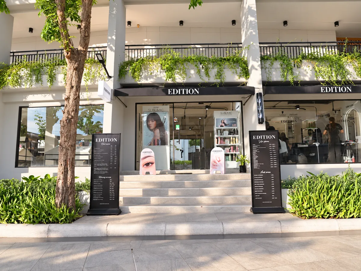 EDITION Salon storefront with black EDITION awnings, front steps and menu boards
