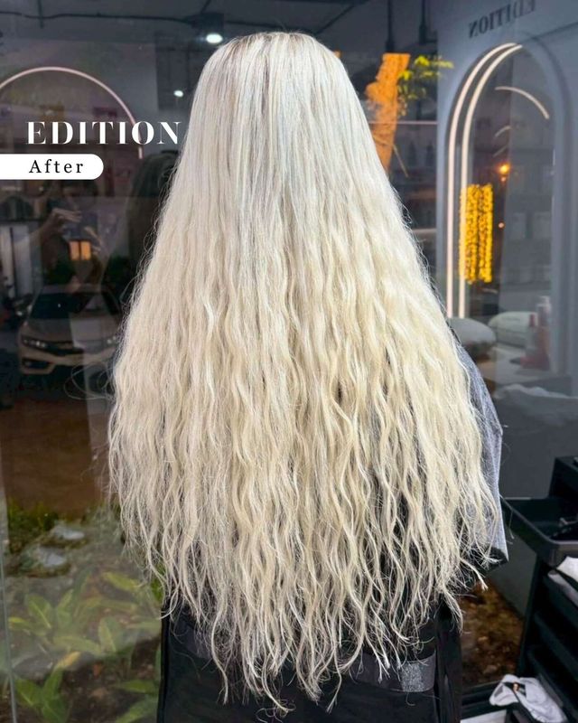 EDITION Salon Pattaya — human hair weft extension result showing dramatically long, full, platinum blonde wavy hair after transformation